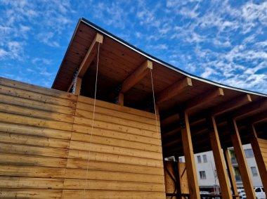 terrace with wooden pergola and plexiglass roof. vines are straining, crawling under the beams. garden or park. sitting with dry wall wine region. restaurant countryside france, truss