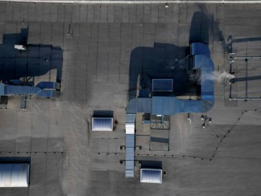 A lightning conductor is used to protect buildings from lightning that can damage a house or its electrical equipment is routed to the highest points of a green garden roof.