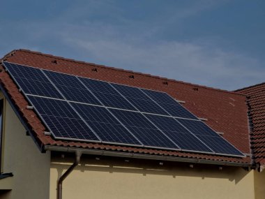 photovoltaic home solar panels only work when it is sunny. at snow and low temperatures the performance decreases exponentially. large silicon roof elements, hedge, green, brown, every roof covered