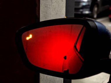 backing up in an underground garage. look in the mirrors and the red brake lights illuminated the whole area. blind spot monitoring warning light radar clipart