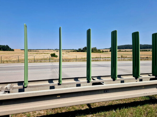 Anti glare screens used to prevent drivers from being dazzled by oncoming vehicles on two-way roads separated by steel or concrete barriers