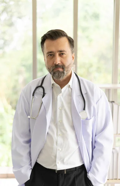 Caucasian physician portrait. Doctor with stethoscope portrait in uniform at hospital. Healthcare and medicine concept.