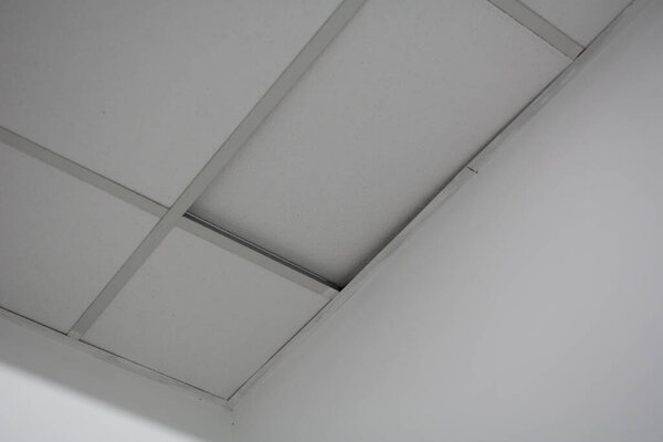 Ceiling tiles peeled off the ceiling. Poor quality damaged pvc ceiling tiles. Poor ceiling repair.