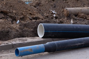 Sanitary piping. Plastic stacked PVC plastic industrial pipes. Plastic stacked PVC industrial pipes construction of housing project drainage canalization sewage. Selective focus