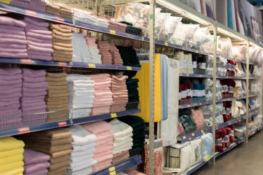 Chisinau, Moldova - 6 Kasım 2022: Yastıklar, havlular, ekose kumaşlar, battaniyeler ve diğer ev giysileri süpermarket metro nakit taşımacılığında raflarda. Seçici odak, yüzeysel alan derinliği