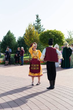 Bender, Tiraspol - October, 2023 a woman and a man in national Moldavian costumes at a festival of wine in Moldova. clipart