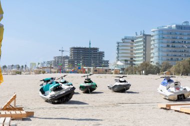 Mamaia, Constanta, Romania - 8, September 2023: Jet skis on the beach with a hotel under construction in the background. Selective focus clipart