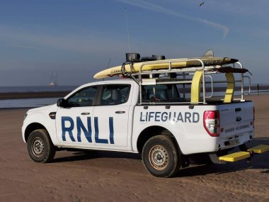 RNLI patrol vehicle on Crosby Beach, England, Europe, UK patrolling the beach for the safety of the many visitors 