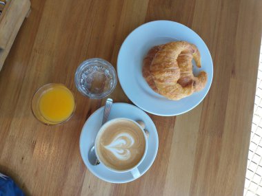 coffee with milk and croissants, breakfast in cafe