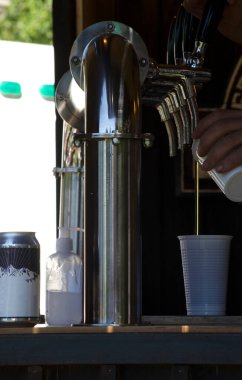 serving craft draft beer in plastic cup in beer yard