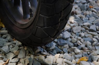 motorcycle wheel circulating on the stone. rubber of a new motorcycle on stony ground