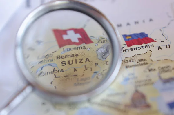 map of switzerland and lichtenstein seen over magnifying glass on a european map