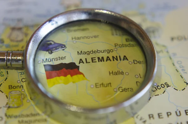 map of germany under magnifying glass with several german cities on map of europe