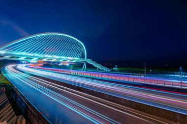 Güzel ve romantik renkli araba ışık yolu. Beyaz köprünün gece manzarası. Uzun pozlu fotoğrafçılık ışık izi görüntülerini yakalar. Harp Köprüsü, Xiangshan Bölgesi, Hsinchu Bölgesi.