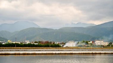 Beautiful countryside landscape at dusk. House, water field and mountain. Dongshan River Water Park. Sanxing Township, Yilan County, Taiwan