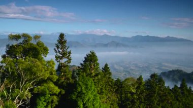 The valleys and mountains are shrouded in mist. Lush hilltops. Looking far away from the top of the mountain. Dahu Township, Miaoli County, Taiwan