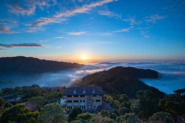 Layers of surging clouds are very spectacular. Sunset behind the mountains. The sea of clouds landscape. Dahu Township, Miaoli County, Taiwan