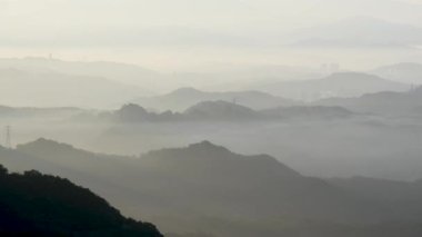 White clouds shuttle between layers of mountains. Hazy and dreamy scenery. Jiufen is an old mountain village. Ruifang District, New Taipei City, Taiwan