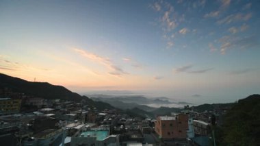 A village surrounded by mountains and sea. The blue sky and colorful clouds. Jiufen at dusk. Ruifang District, New Taipei City, Taiwan