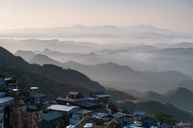 A village surrounded by mountains and sea. The blue sky and colorful clouds. Jiufen at dusk. Ruifang District, New Taipei City, Taiwan