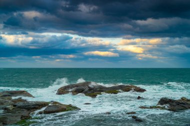 Looking at the vast sea and blowing the sea breeze, it is even more refreshing. Waves lapping at the rocks at dusk. Badouzi Coastal Park, Keelung City, Taiwan