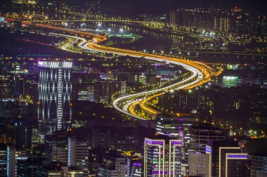 Fantezi turuncu gökyüzü. Taipei şehrinin hareketli ve hareketli gece sahnesi. Dağlarla çevrili şehrin gece manzarası puslu ve rüya gibi. Dajianshan, Tayvan