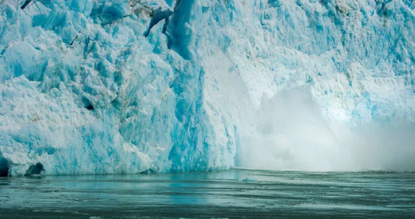 stock image Spectacular glacier calving. Ice cubes fell into the water like an explosion. Rocks, Ice, Rivers, Forests and Mountains: The Summer Scenery of Alaska. 