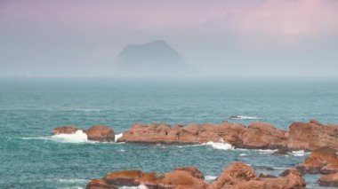 Sis, mavi deniz ve mavi gökyüzü ile kaplanmış küçük bir ada. New Taipei 'deki Wanli Sahili' nden Keelung Adası manzarası. Tayvan.