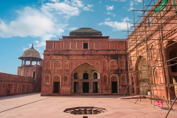 Decorative ritual pool( fountain) in Red Fort of Agra, India. Under renovation. Agra Fort is a historic red sandstone fort and a UNESCO World Heritage Site.