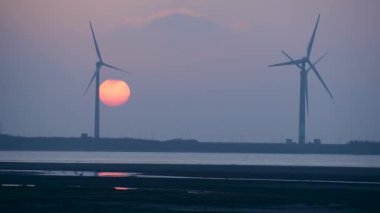 Burası fotoğraf çekmek, manzaranın tadını çıkarmak ya da gün batımını izlemek için harika bir yer. Gaomei Windmill Caddesi. Taichung Liman Rüzgarı Güç İstasyonu. Tayvan.