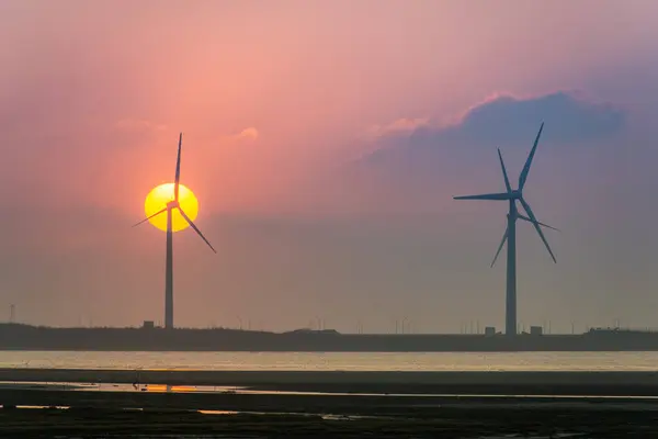 Offshore wind farms are great for enjoying the scenery and watching the sunset. Gaomei Windmill Avenue. Taichung Harbor Wind Power Station. Taiwan.