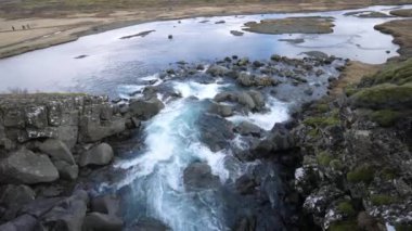 Dünyanın tektonik gücünü gösteren sakin bir dere Thingvellir Ulusal Parkı 'nın muhteşem yarık vadisinde dolanıyor. Jeolojik harikalar, İzlanda.