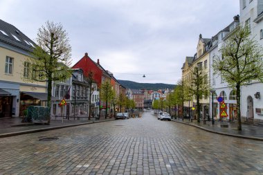Bergen, Norveç - 30 Nisan 2024: Yağmurdan sonra Bergen 'de sakin bir cadde. Renkli binalar ve kaldırım taşlı yollar büyüleyici bir Avrupa atmosferi yaratır..