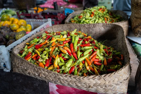 A basket full of fresh Indonesian chili peppers, also called rawit or bird's eye chili, horizontal