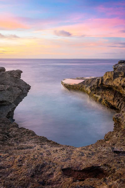 stock image Logn exposure shot of sunset at Devil's tears at Nusa Lembongan island, Indonesia, vertical