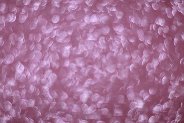 Pembe parıltılı arka plan. Bokeh ışıkları ve yıldızlarla odaklanmış soyut bir arkaplan. Noel bayramı kutlaması. yeni yıl arkaplanı.