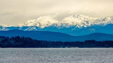 Thick clouds hang over the Olympic Mountains in Washington State.