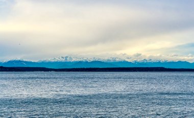 Thick clouds hang over the Olympic Mountains in Washington State.