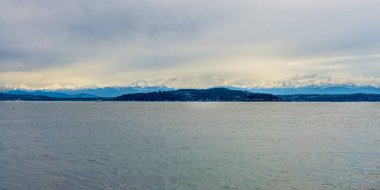 Thick clouds hang over the Olympic Mountains in Washington State.