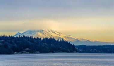 Clouds cover Mount Rainier across the Puget Soud in Washington State.