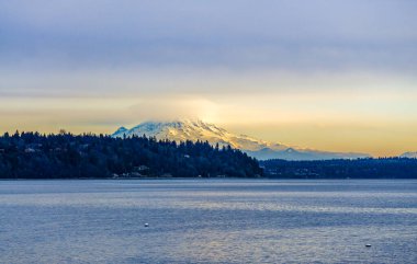 Clouds cover Mount Rainier across the Puget Soud in Washington State.