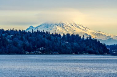 Clouds cover Mount Rainier across the Puget Soud in Washington State.