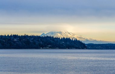 Clouds cover Mount Rainier across the Puget Soud in Washington State.