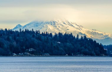 Clouds cover Mount Rainier across the Puget Soud in Washington State.