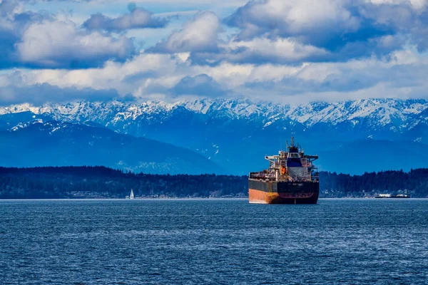 stock image A tanker ship in Elliott Bay with the Olympic Mouintain range in the distance.