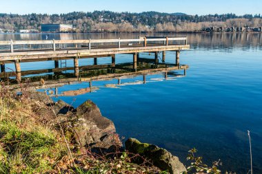 A pier along the shore of Mercer Island in Washington State. clipart