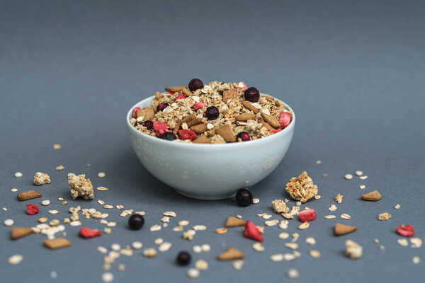 A bowl of muesli on a gray monochrome background, healthy food, healthy breakfast