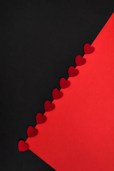 Black and red background decorated with red hearts, a banner for discounts or congratulations
