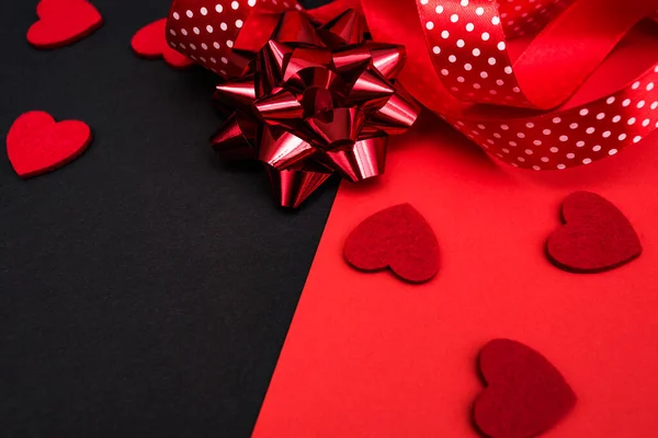 Black and red background with a red ribbon, a sprig of ivy and hearts. Banner with a place for the inscription