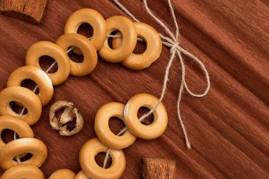 Kahverengi kıvrımlı kağıdın üzerinde duran bir demet simit. Tatlı olarak pişiriyorum.